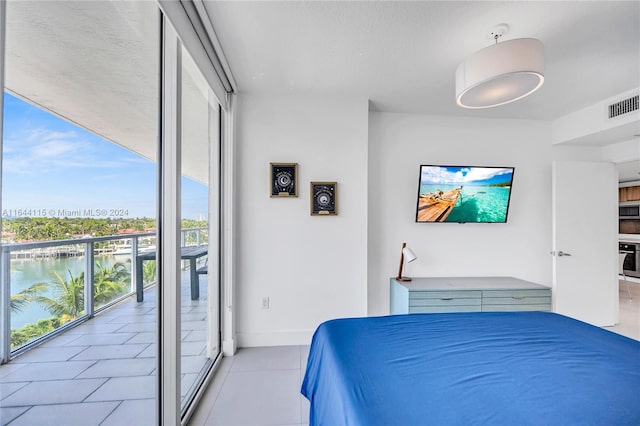 tiled bedroom featuring a water view