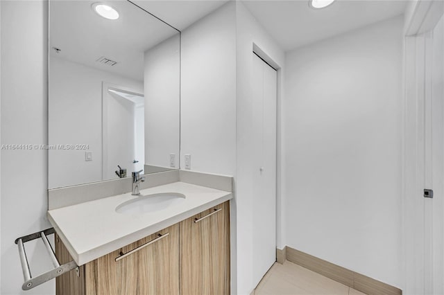 bathroom with tile patterned floors and vanity