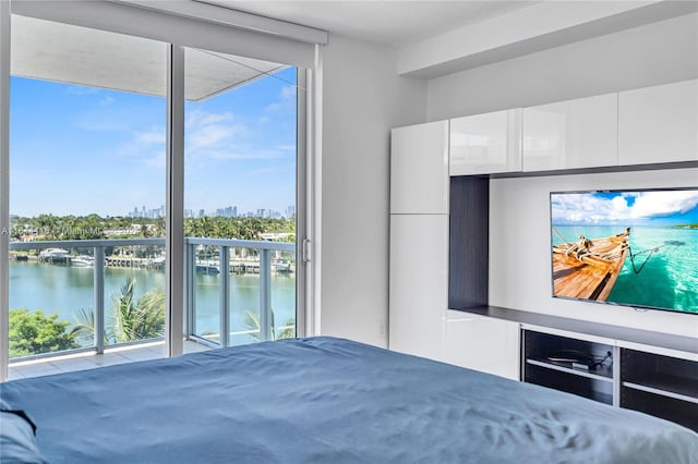 unfurnished bedroom with a wall of windows and a water view