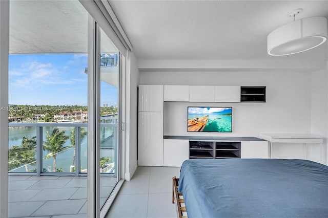 tiled bedroom with a water view