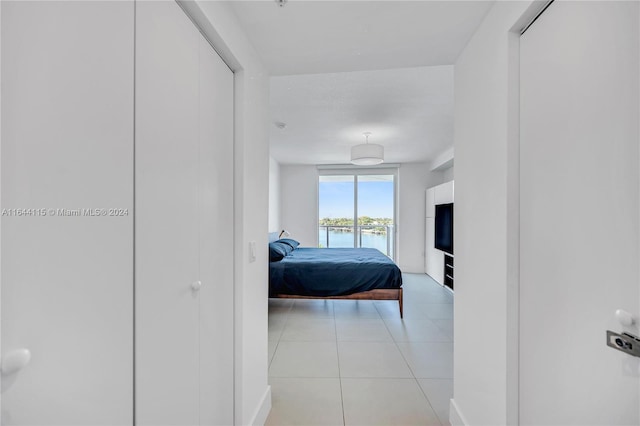 hall featuring light tile patterned flooring