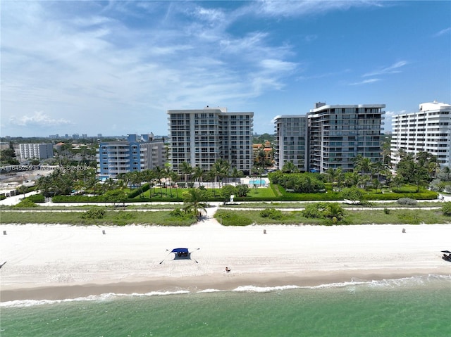 birds eye view of property with a view of the beach and a water view