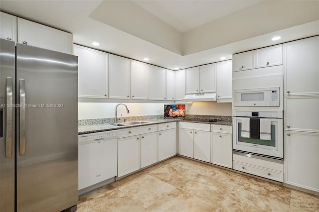 kitchen with sink, white cabinets, white appliances, and light tile patterned floors