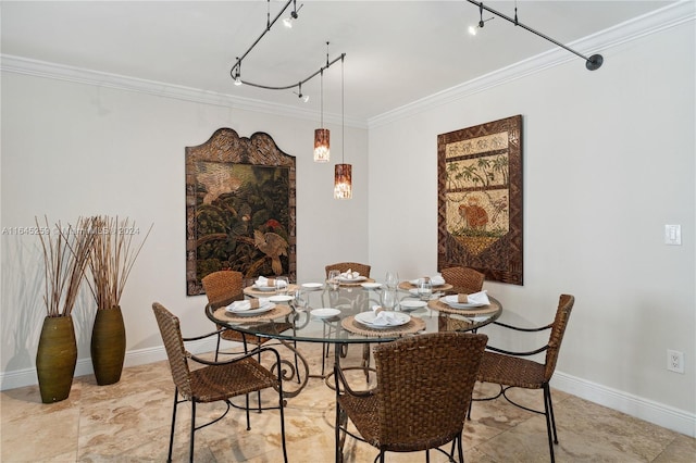 tiled dining room with track lighting and ornamental molding