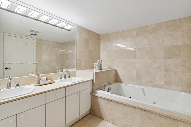 bathroom featuring a relaxing tiled tub, double vanity, tile patterned flooring, and tile walls