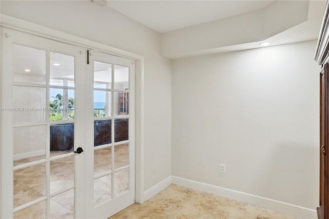 spare room with light tile patterned floors and french doors