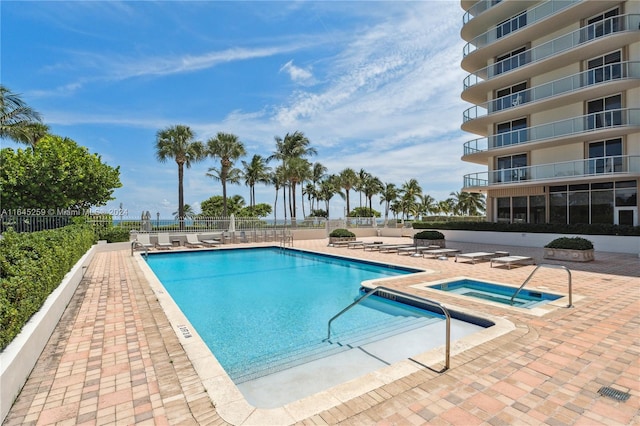 view of pool featuring a hot tub and a patio