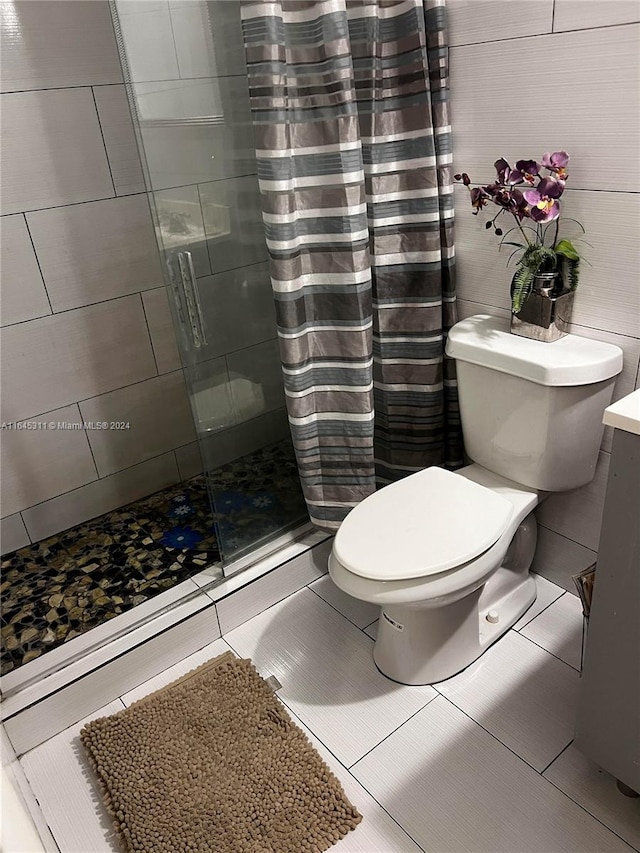 bathroom with toilet, walk in shower, and tile patterned floors