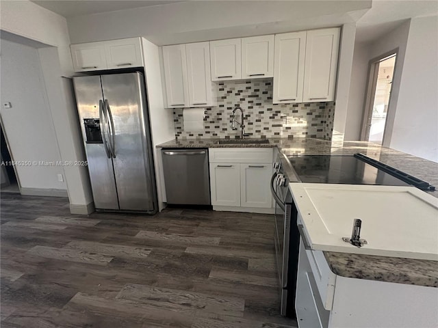 kitchen with white cabinets, appliances with stainless steel finishes, dark wood-type flooring, and sink