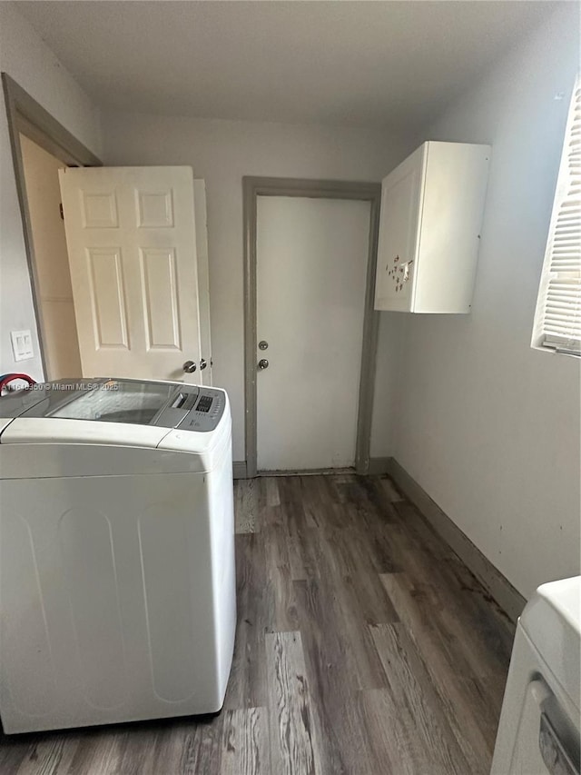 laundry room featuring washer and dryer, cabinets, and dark wood-type flooring