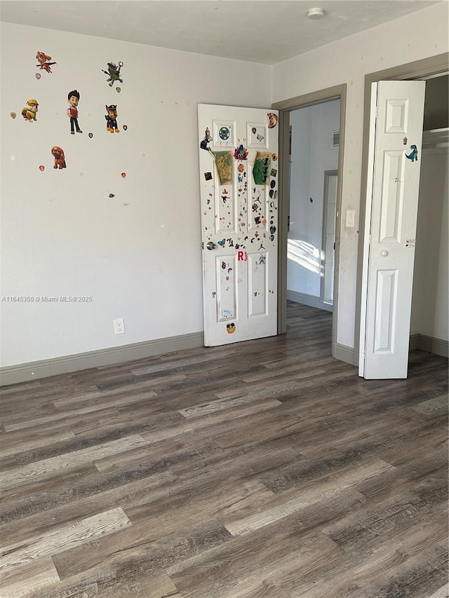 unfurnished bedroom featuring dark hardwood / wood-style floors