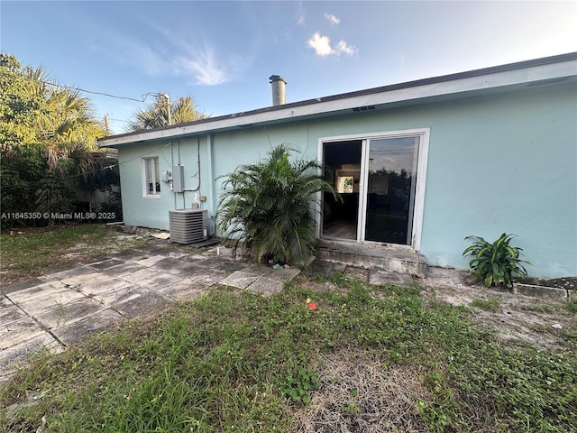 back of property featuring central AC unit and a patio