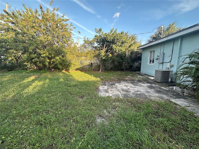 view of yard featuring cooling unit and a patio