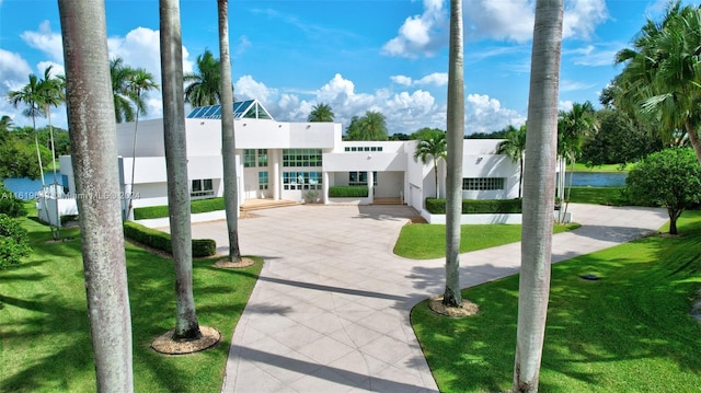 view of community featuring a yard and a water view