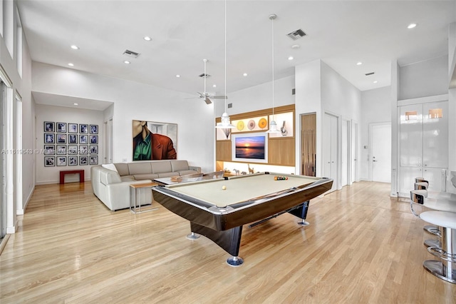 game room with billiards, a high ceiling, light wood-type flooring, and ceiling fan