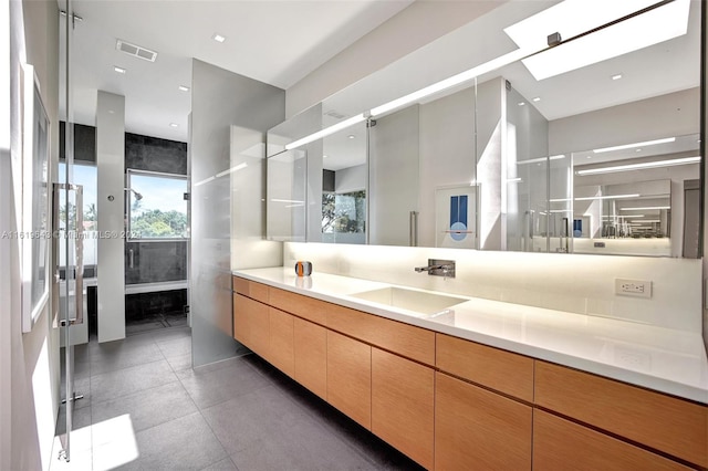 bathroom featuring vanity and a skylight