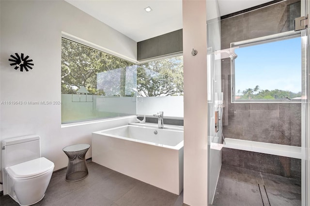 bathroom featuring toilet, a healthy amount of sunlight, separate shower and tub, and tile patterned flooring