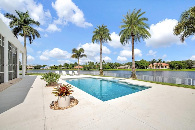 view of swimming pool featuring a water view and a patio area