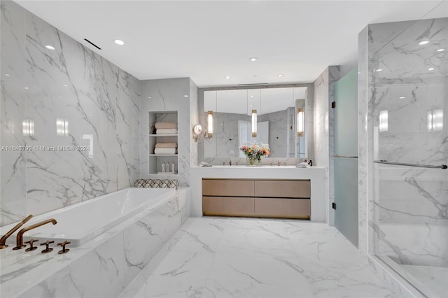 bathroom with tile patterned floors, separate shower and tub, vanity, and tile walls