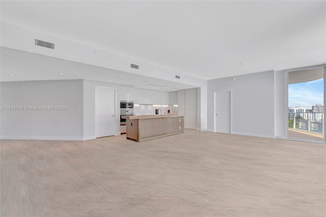 unfurnished living room with sink