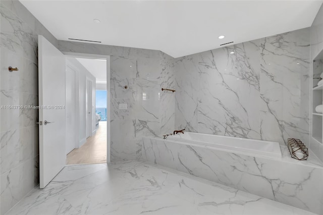 bathroom featuring tile patterned flooring and tile walls