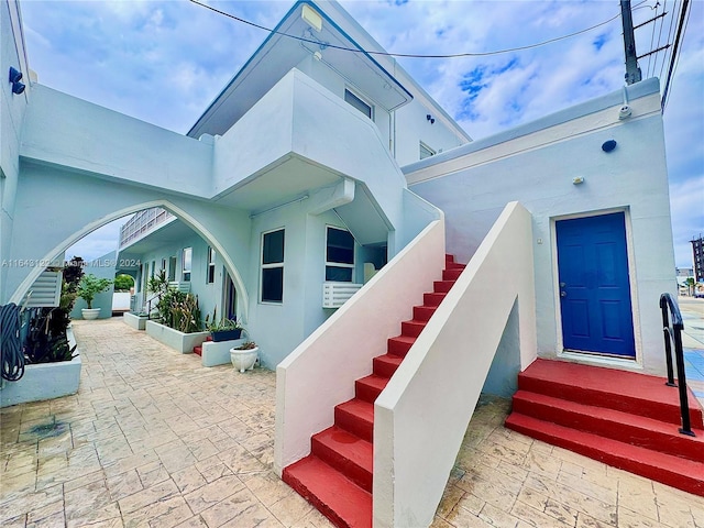 entrance to property featuring stucco siding