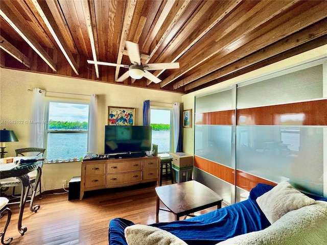 living room with hardwood / wood-style flooring, beam ceiling, ceiling fan, and wood ceiling