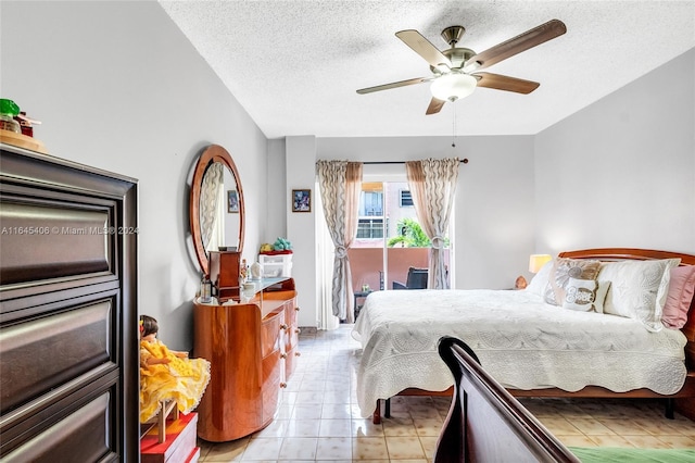 tiled bedroom featuring a textured ceiling, access to outside, and ceiling fan