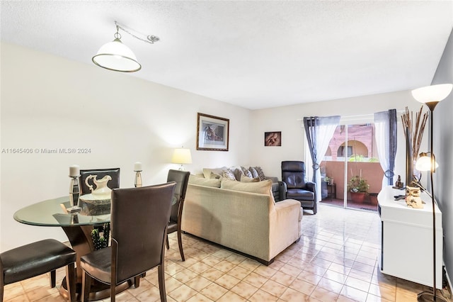 living room featuring light tile patterned floors and a textured ceiling