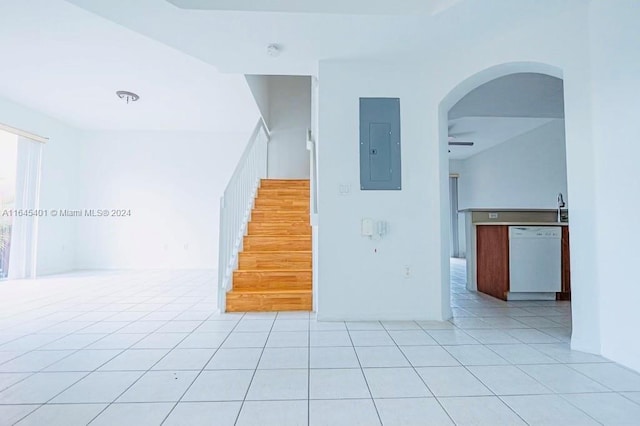 interior space with tile patterned flooring, electric panel, and arched walkways