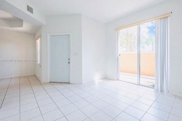 spare room with visible vents and light tile patterned flooring