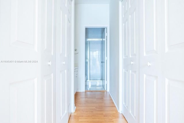 hallway with light hardwood / wood-style flooring