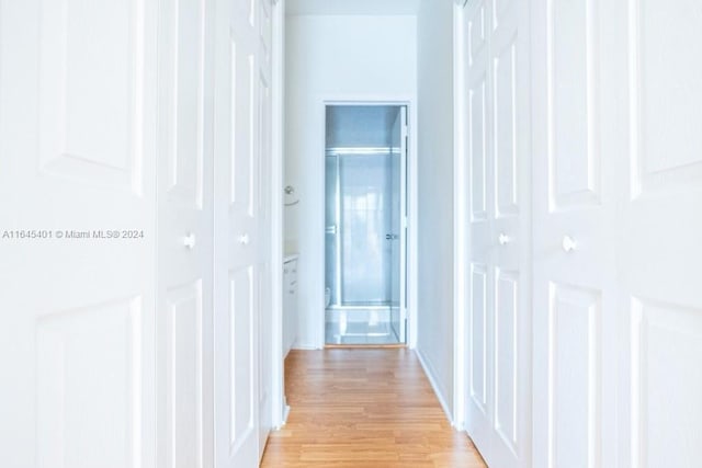 corridor with light wood-style flooring