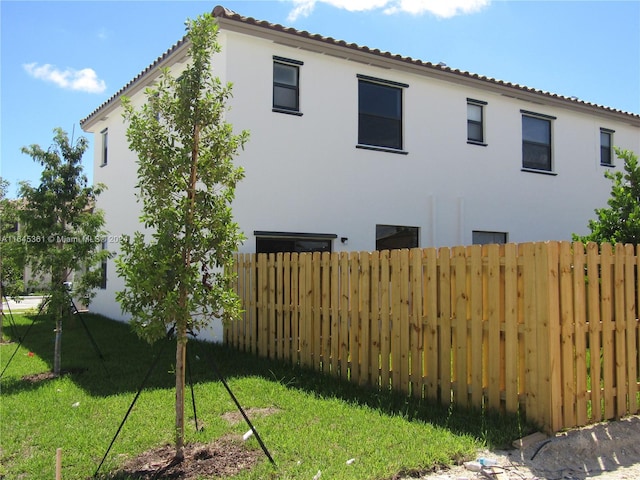 rear view of property with a lawn