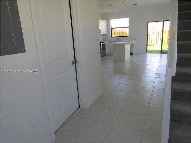 corridor featuring light tile patterned flooring