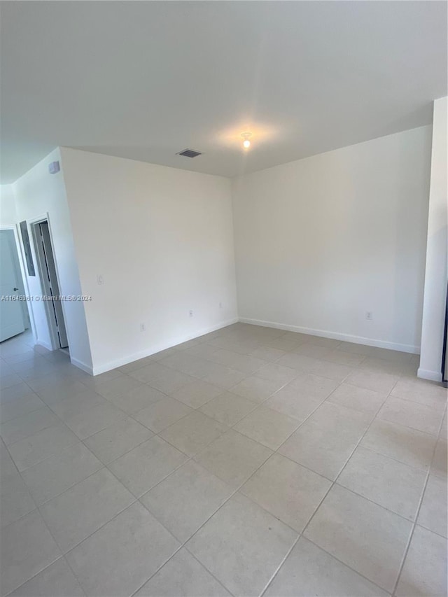 unfurnished room with light tile patterned floors