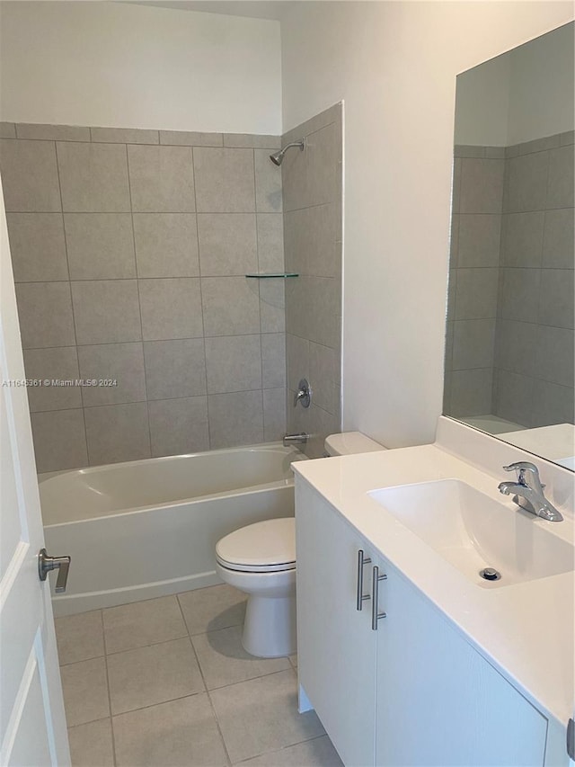 full bathroom featuring tile patterned floors, toilet, tiled shower / bath, and vanity