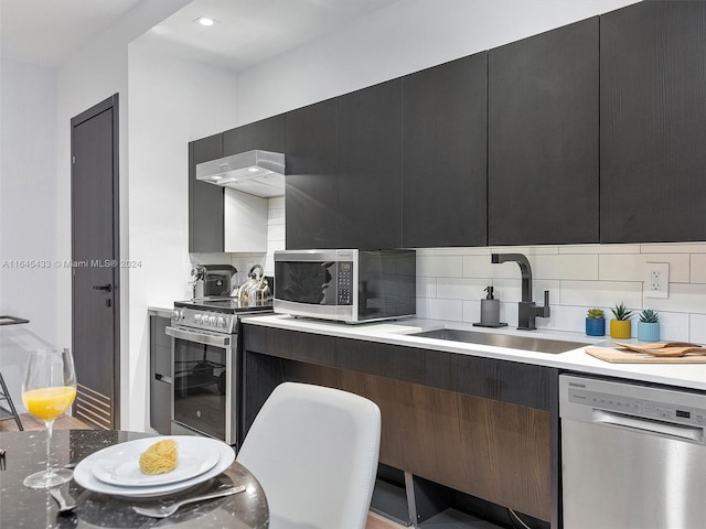 kitchen with light countertops, appliances with stainless steel finishes, modern cabinets, and a sink