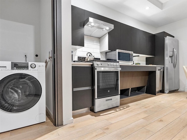 kitchen featuring washer / dryer, modern cabinets, appliances with stainless steel finishes, and dark cabinets