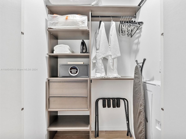 walk in closet with wood finished floors