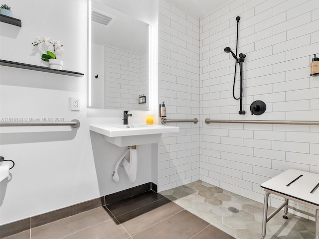 bathroom with tiled shower, visible vents, and tile patterned floors