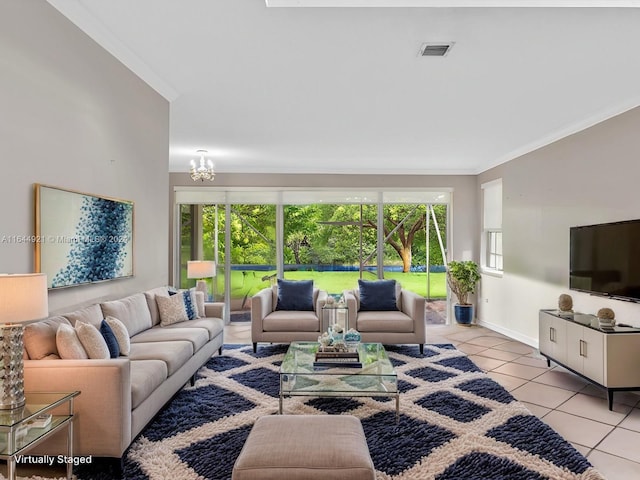 living room with a chandelier, light tile patterned floors, crown molding, and a healthy amount of sunlight