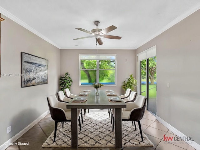 tiled dining room with ceiling fan and crown molding