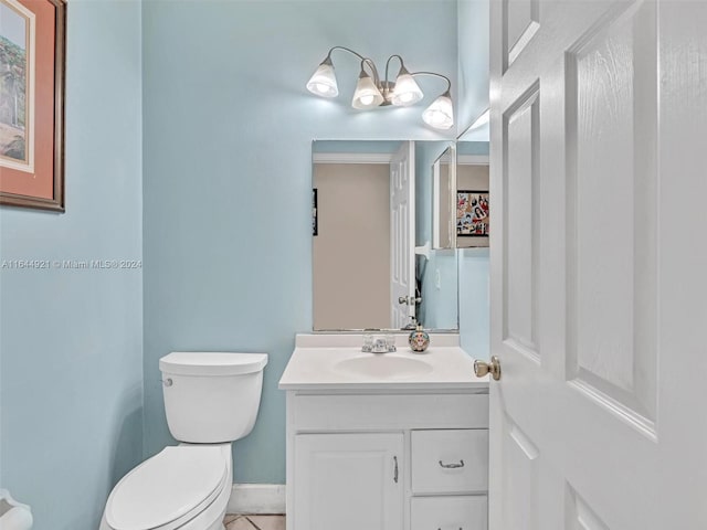 bathroom with tile patterned flooring, vanity, and toilet