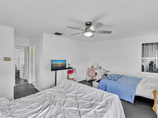 bedroom featuring a textured ceiling and ceiling fan