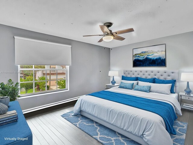 bedroom with ceiling fan and wood-type flooring