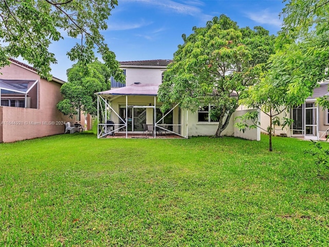 rear view of house with a yard