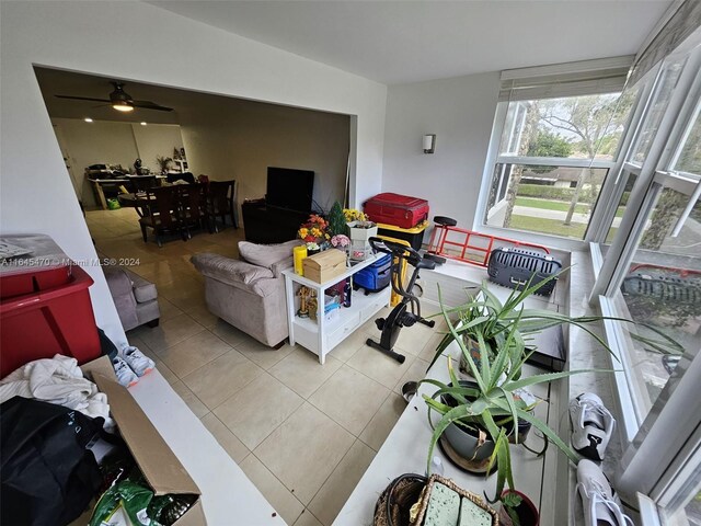 living room with tile patterned flooring and ceiling fan