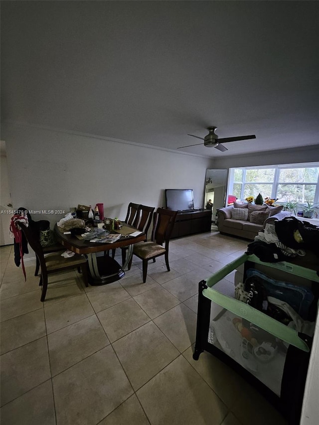 living area featuring tile patterned flooring and ceiling fan