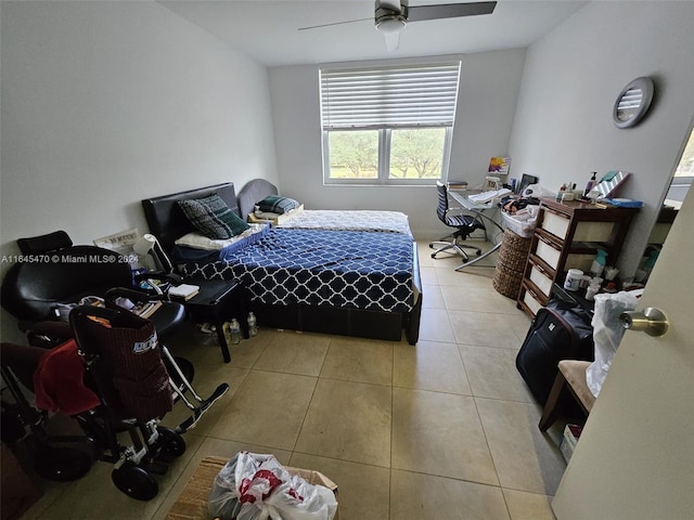 tiled bedroom featuring ceiling fan